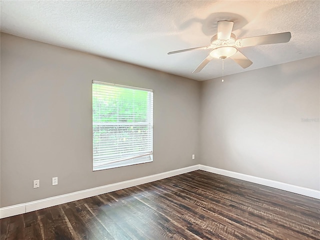 spare room with dark wood-type flooring, a textured ceiling, and ceiling fan