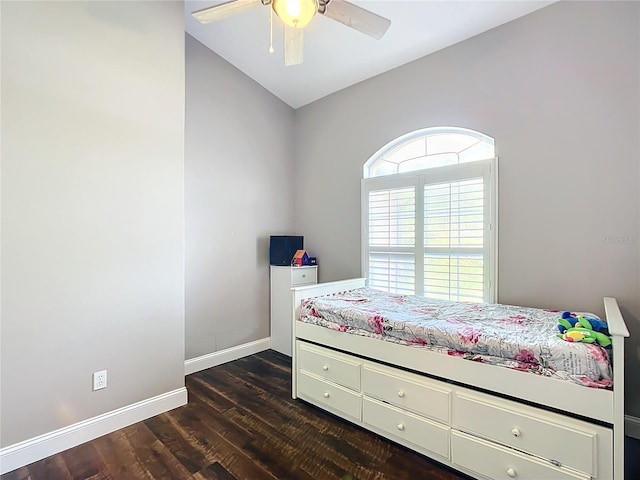 bedroom with dark wood-type flooring, vaulted ceiling, and ceiling fan