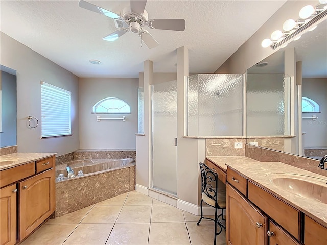 bathroom with vanity, a textured ceiling, ceiling fan, and tile patterned floors