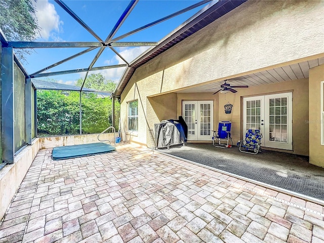 unfurnished sunroom featuring french doors and ceiling fan