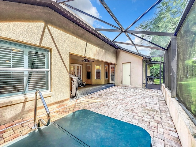 unfurnished sunroom featuring ceiling fan