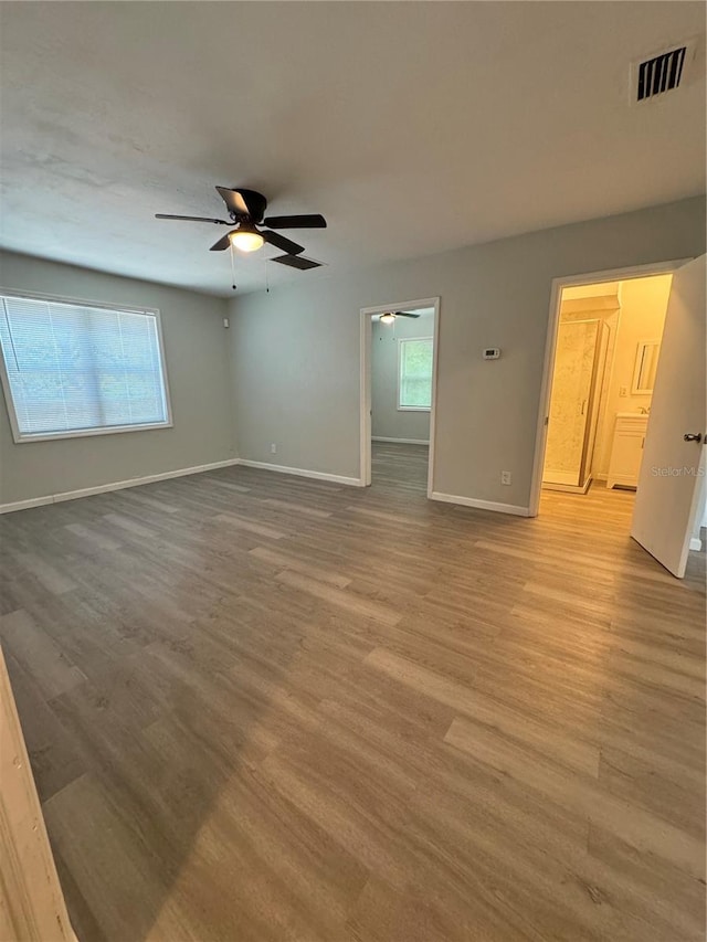 unfurnished room featuring hardwood / wood-style floors and ceiling fan