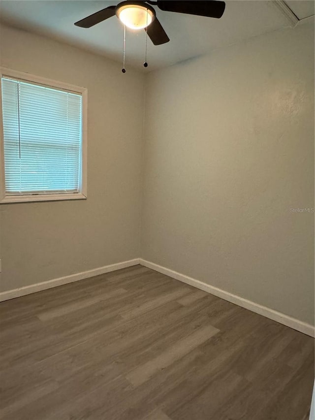 unfurnished room featuring ceiling fan and dark hardwood / wood-style floors