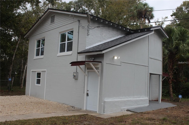 view of home's exterior with roof with shingles