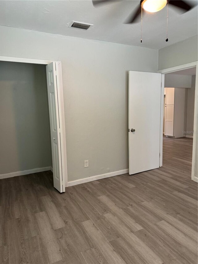 unfurnished bedroom with ceiling fan and hardwood / wood-style floors