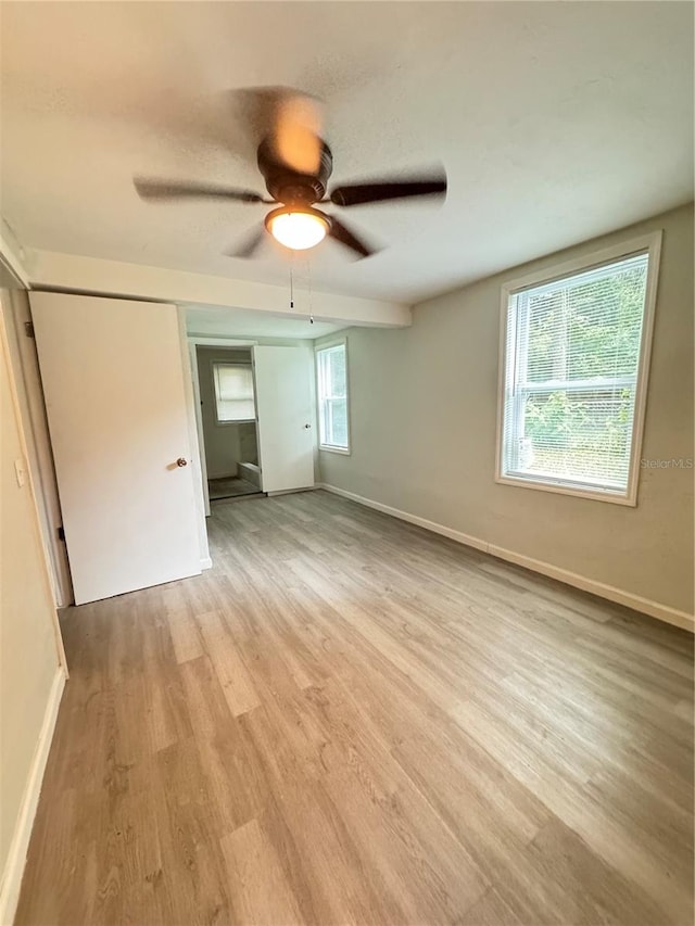 unfurnished bedroom with light hardwood / wood-style flooring and ceiling fan