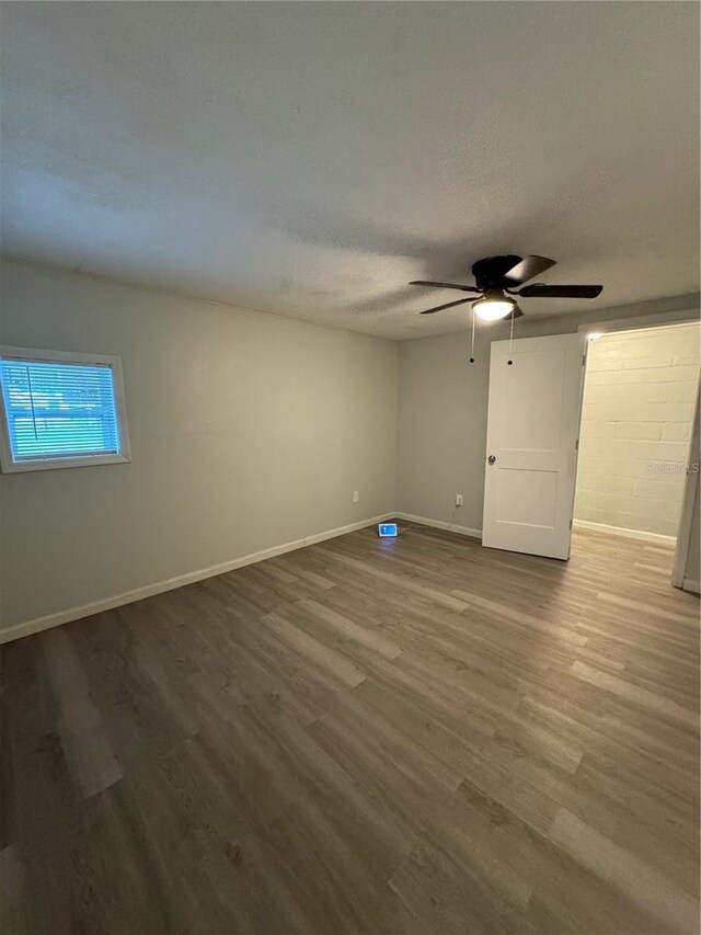 unfurnished room featuring a textured ceiling, ceiling fan, and hardwood / wood-style floors