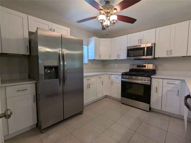 kitchen with white cabinetry, appliances with stainless steel finishes, light tile patterned floors, and ceiling fan