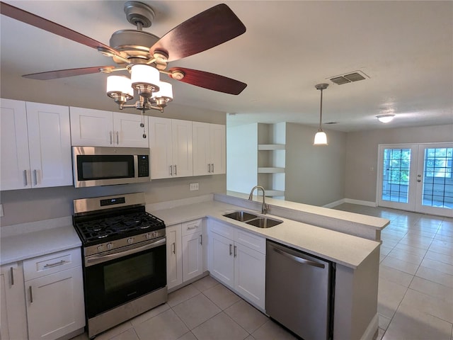 kitchen with stainless steel appliances, white cabinets, sink, kitchen peninsula, and ceiling fan