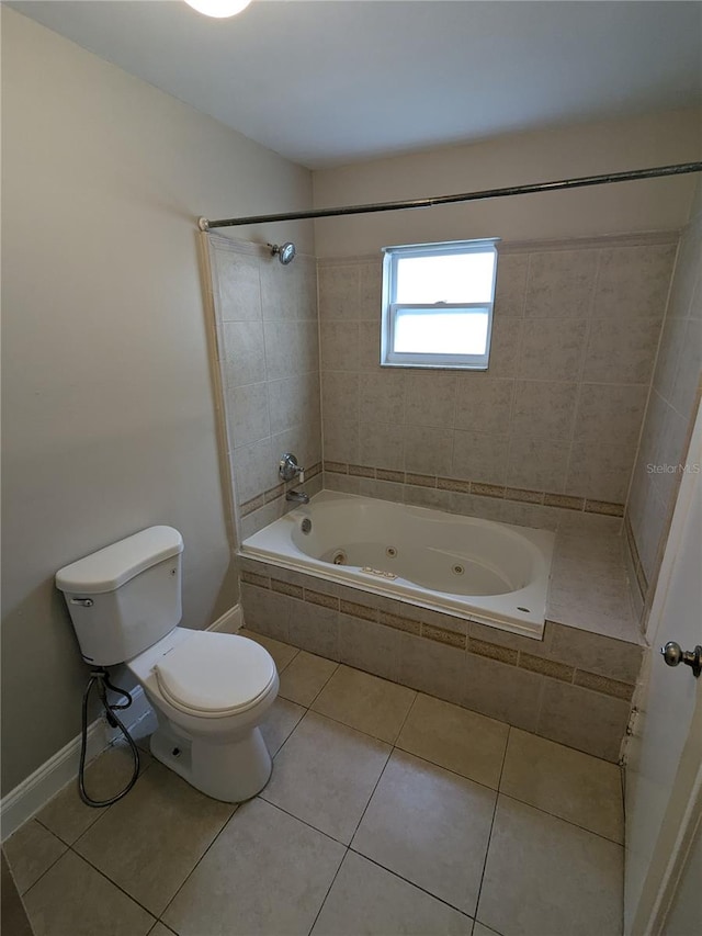 bathroom featuring toilet, tiled shower / bath, and tile patterned flooring