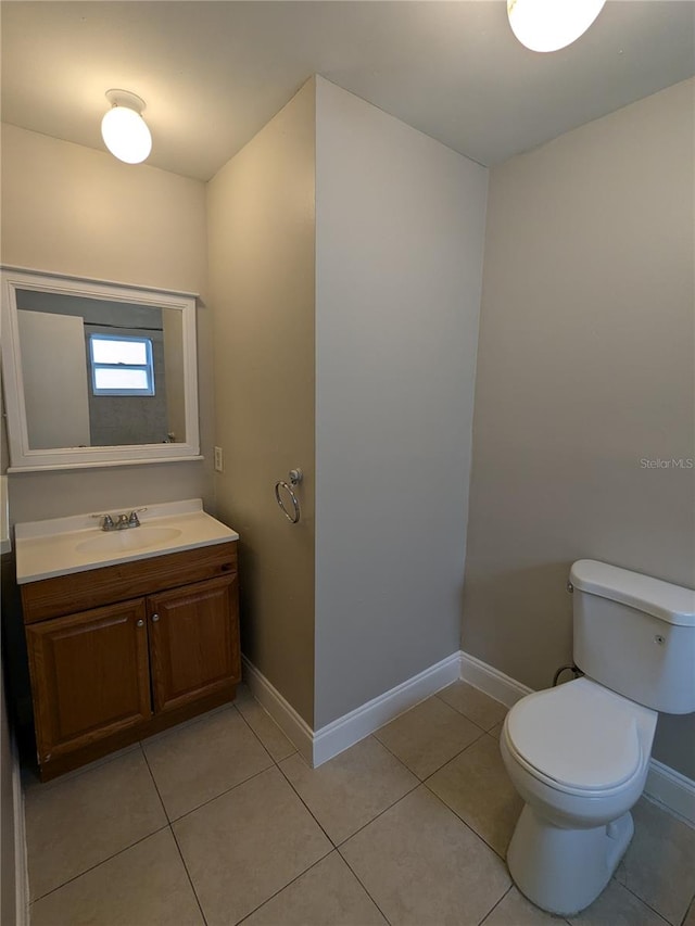 bathroom featuring vanity, toilet, and tile patterned flooring