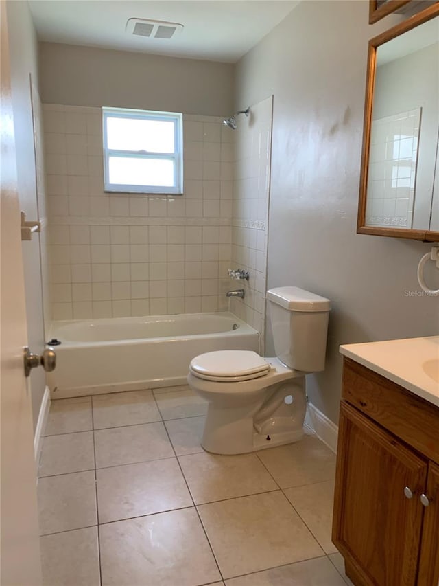 full bathroom with vanity, tiled shower / bath, and toilet