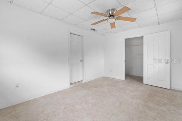 unfurnished bedroom featuring visible vents, a paneled ceiling, and ceiling fan