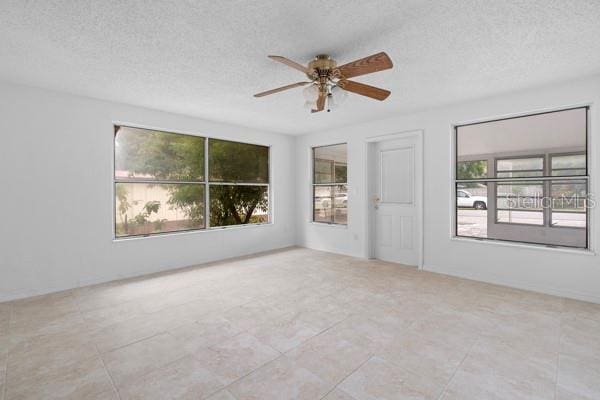 unfurnished room featuring a textured ceiling and ceiling fan