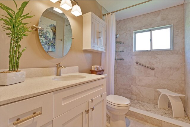 bathroom with tile patterned flooring, toilet, vanity, and a shower with shower curtain