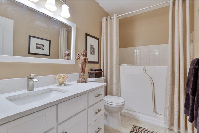 bathroom with vanity, tile patterned flooring, toilet, and tile walls