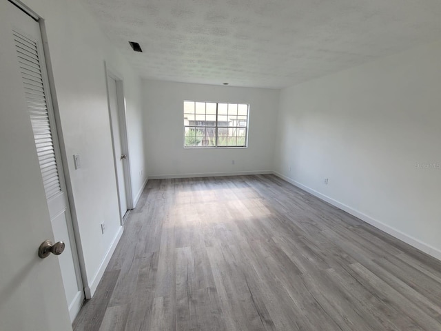 unfurnished room featuring hardwood / wood-style floors