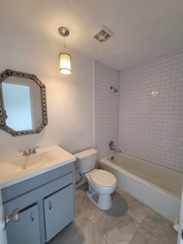 full bathroom featuring vanity, tiled shower / bath, tile patterned flooring, and toilet