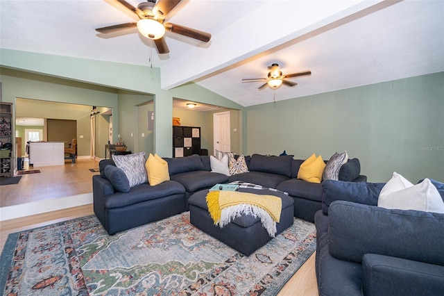 living room with lofted ceiling with beams, light wood-type flooring, and ceiling fan