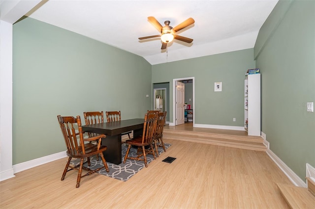 dining area featuring ceiling fan, lofted ceiling, and light hardwood / wood-style floors