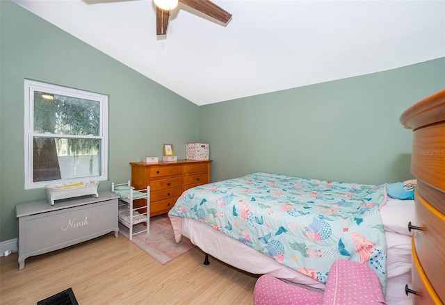 bedroom featuring ceiling fan, lofted ceiling, and light hardwood / wood-style floors