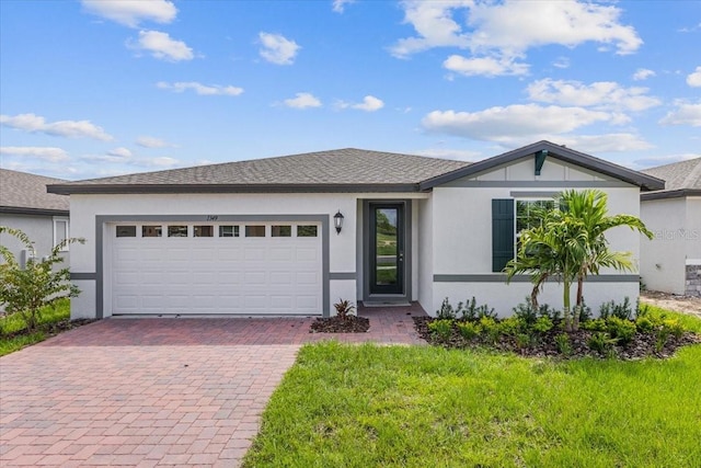 view of front of home with a garage and a front lawn