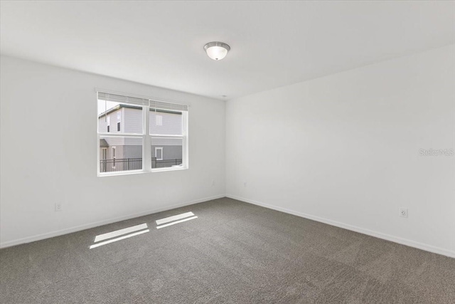 unfurnished room featuring carpet flooring