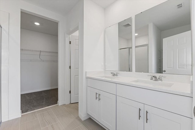 bathroom with vanity and an enclosed shower