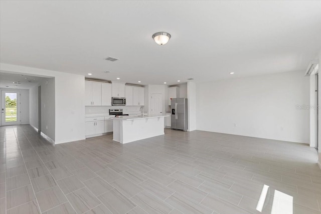 kitchen with a kitchen island with sink, sink, white cabinetry, and stainless steel appliances