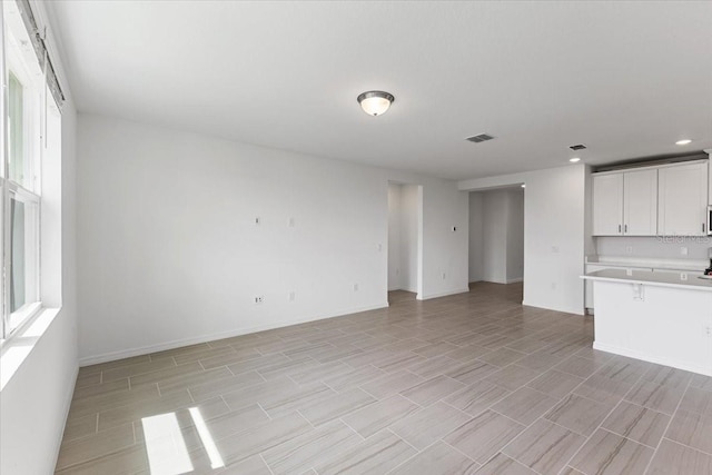 unfurnished living room featuring plenty of natural light