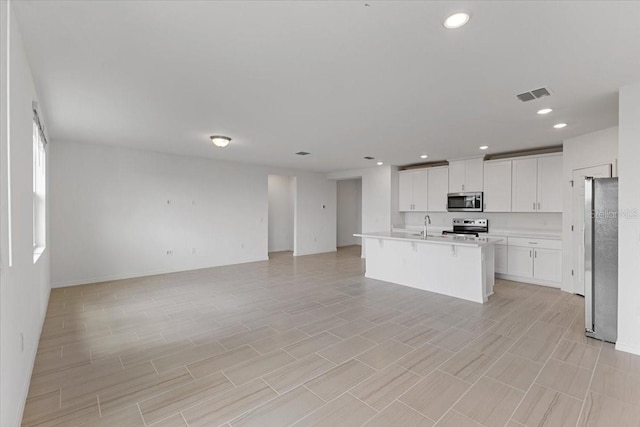 kitchen featuring white cabinetry, sink, a kitchen island with sink, and stainless steel appliances