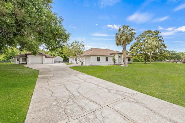 ranch-style house with a garage and a front yard