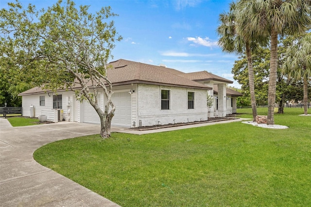 view of front of property featuring a garage and a front yard