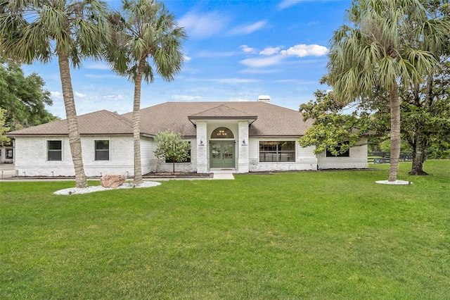 mediterranean / spanish house featuring a front yard