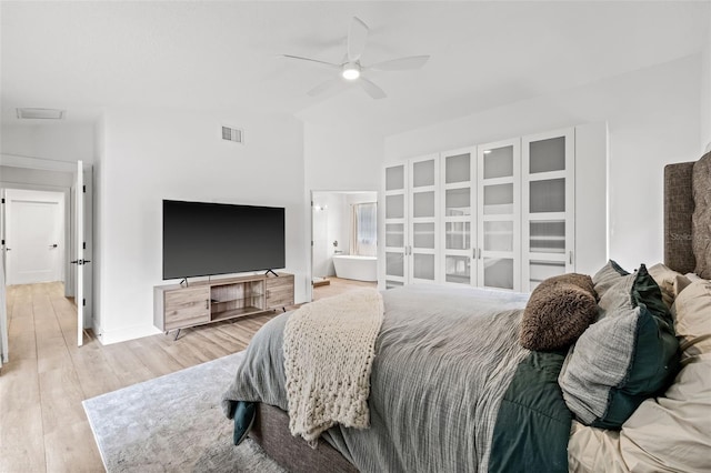 bedroom featuring ceiling fan, lofted ceiling, and light wood-type flooring