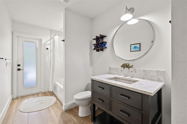 full bathroom featuring hardwood / wood-style flooring, vanity, toilet, and shower / tub combo