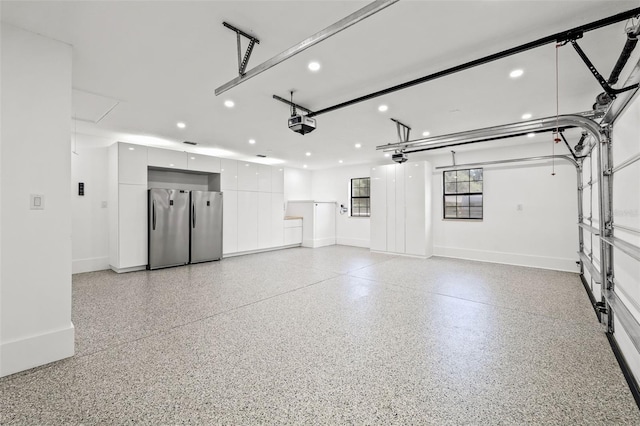 garage featuring a garage door opener and stainless steel fridge