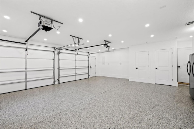 garage featuring a garage door opener and black fridge