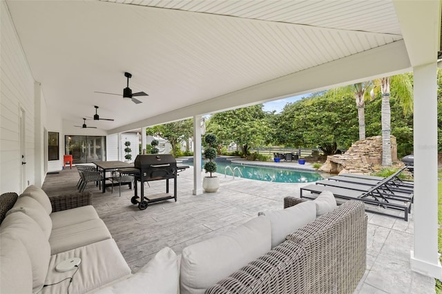 view of patio with area for grilling, an outdoor hangout area, pool water feature, and ceiling fan