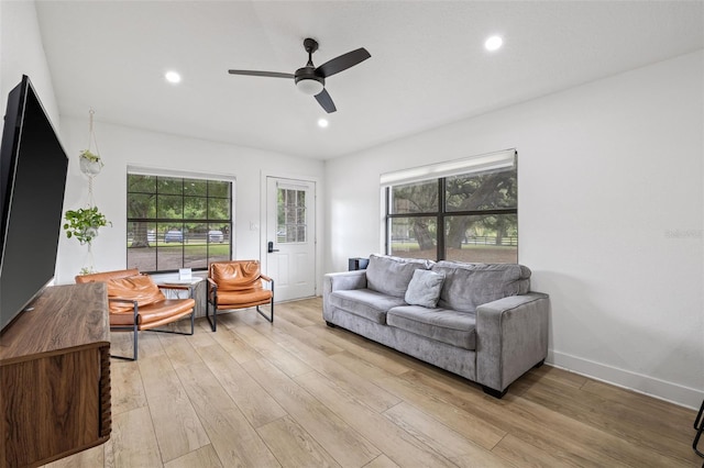 living room with ceiling fan, a healthy amount of sunlight, and light hardwood / wood-style flooring