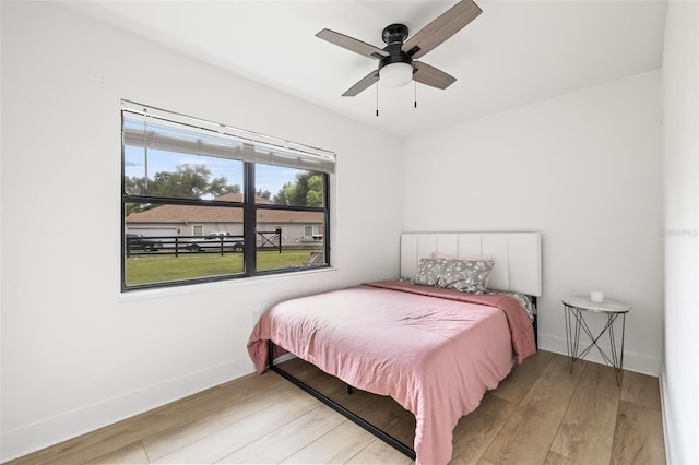 bedroom with ceiling fan and light wood-type flooring