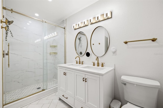 bathroom with a shower with door, vanity, and toilet