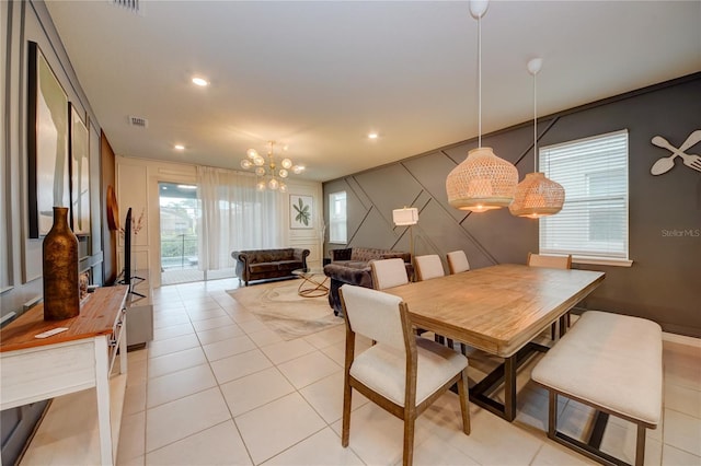 dining space with recessed lighting, visible vents, a decorative wall, and light tile patterned flooring