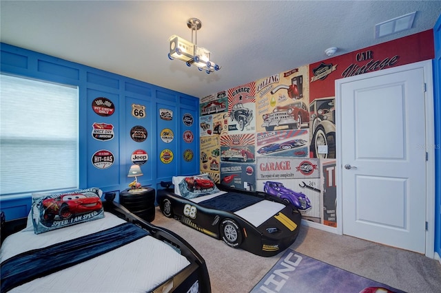 carpeted bedroom featuring visible vents and a textured ceiling