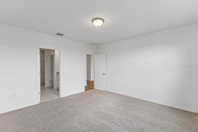 empty room featuring light carpet