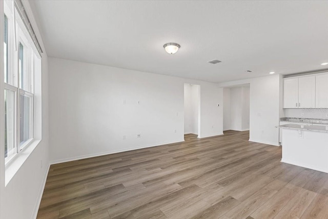 unfurnished living room with light wood-type flooring