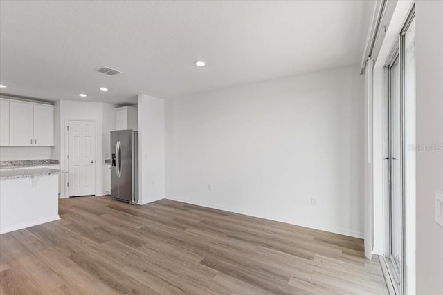 unfurnished living room with light hardwood / wood-style floors