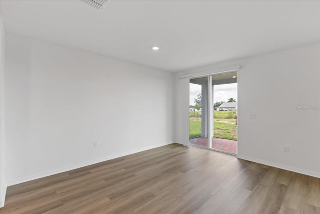 unfurnished room with wood-type flooring