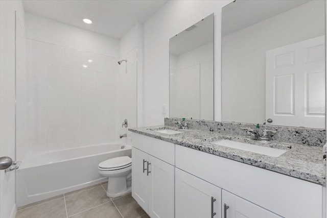 full bathroom featuring tiled shower / bath, vanity, toilet, and tile patterned flooring