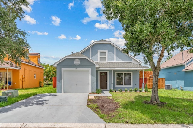 view of front of house featuring a garage, central AC, and a front yard